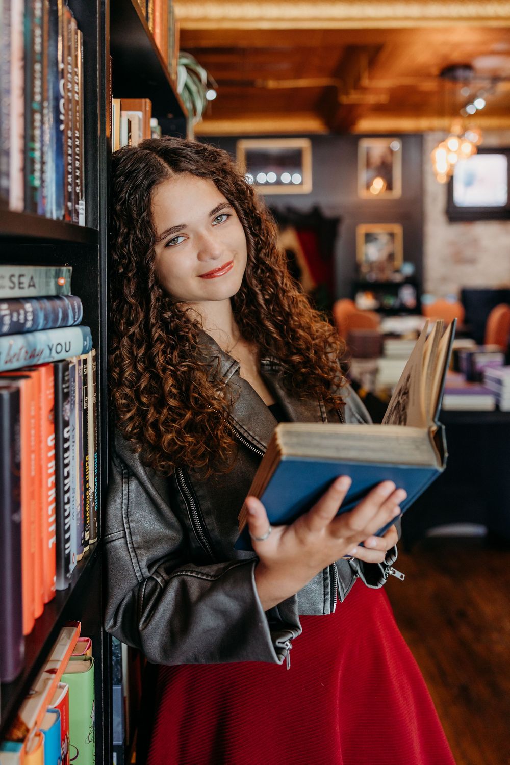 Senior girl at an enchanted bookstore during her portraits. Cincinnati, Northern Kentucky, and Chicago Portrait Photographer.