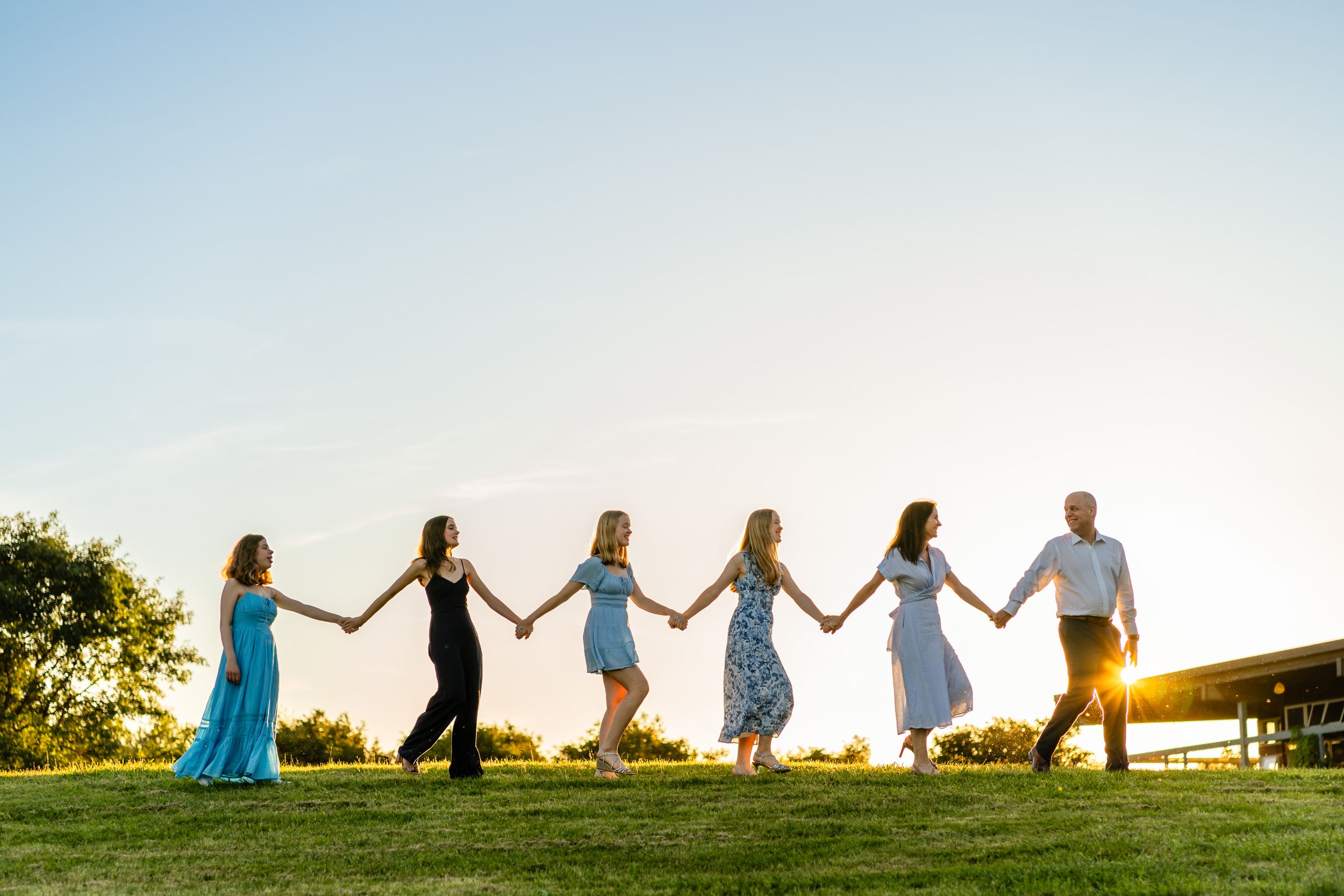 Family walks hand in hand in Seattle with a sunburst.