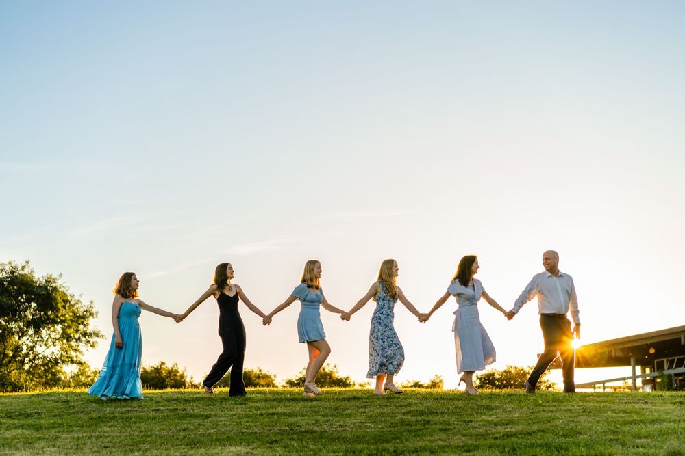 Family walks hand in hand in Seattle with a sunburst.