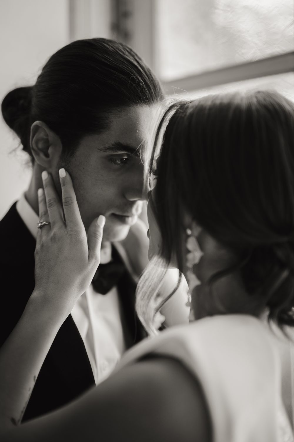 Black and white artistic portrait capturing an intimate romantic moment.