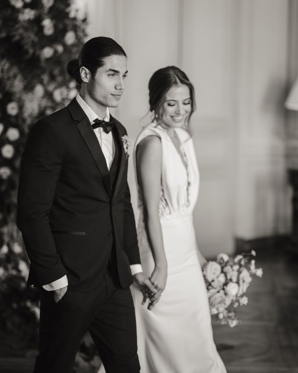 Classic black and white wedding portrait in an elegant indoor setting.