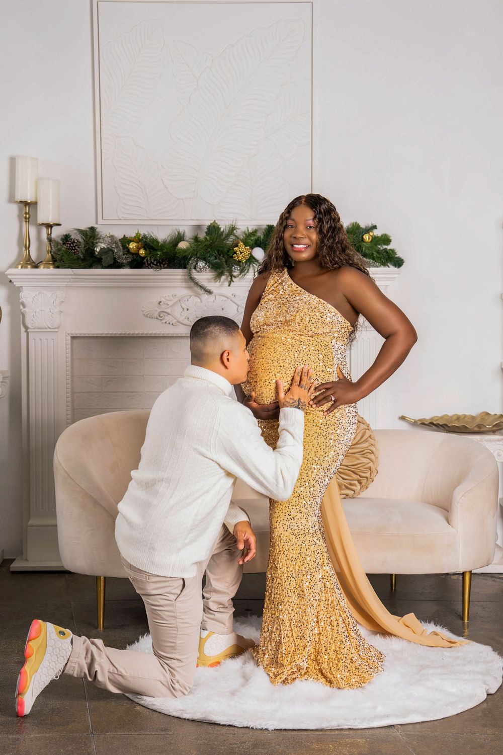 Romantic proposal moment in front of decorated Christmas fireplace with gold dress.