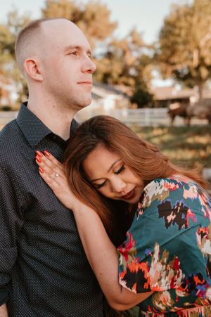 Couple shares intimate moment during golden hour photo shoot in autumn setting.