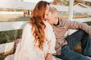 Couple in casual attire shares sweet moments during outdoor photography session.