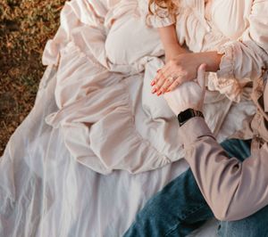 Close-up details of flowing dress and casual attire during romantic outdoor photoshoot.