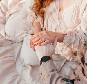 Detailed shots of light pink flowing dress and casual wear during countryside photo session.