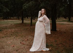 Ethereal outdoor photography session featuring a delicate lace dress against a natural forest backdrop.