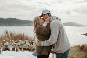 A couple shares their first moments as newly engaged on a scenic overlook.