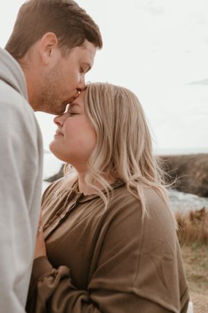 Intimate close-up portrait of a couple in casual attire during an outdoor photoshoot.