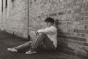 Black and white portraits against brick wall showing different reclining poses.