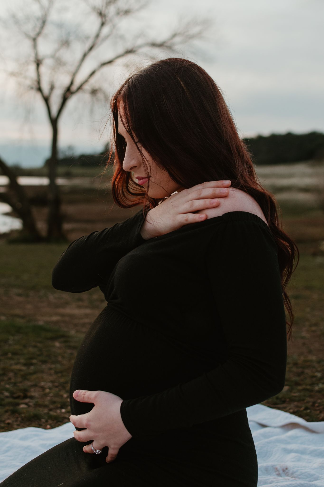 Two people embrace emotionally during an outdoor photo session.