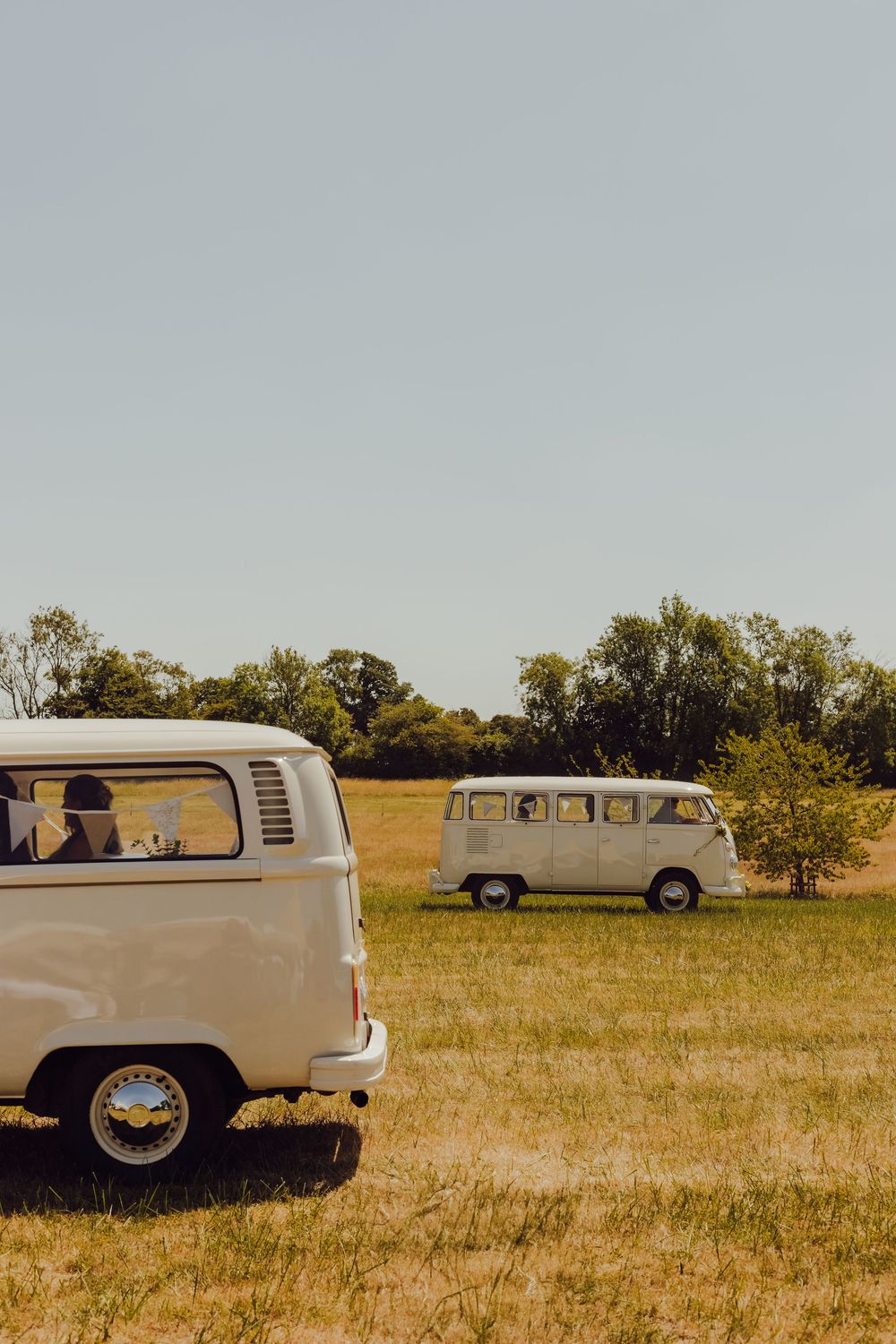 Two vintage wedding vans parked in a field at Amy and James’ wedding in Romsey.