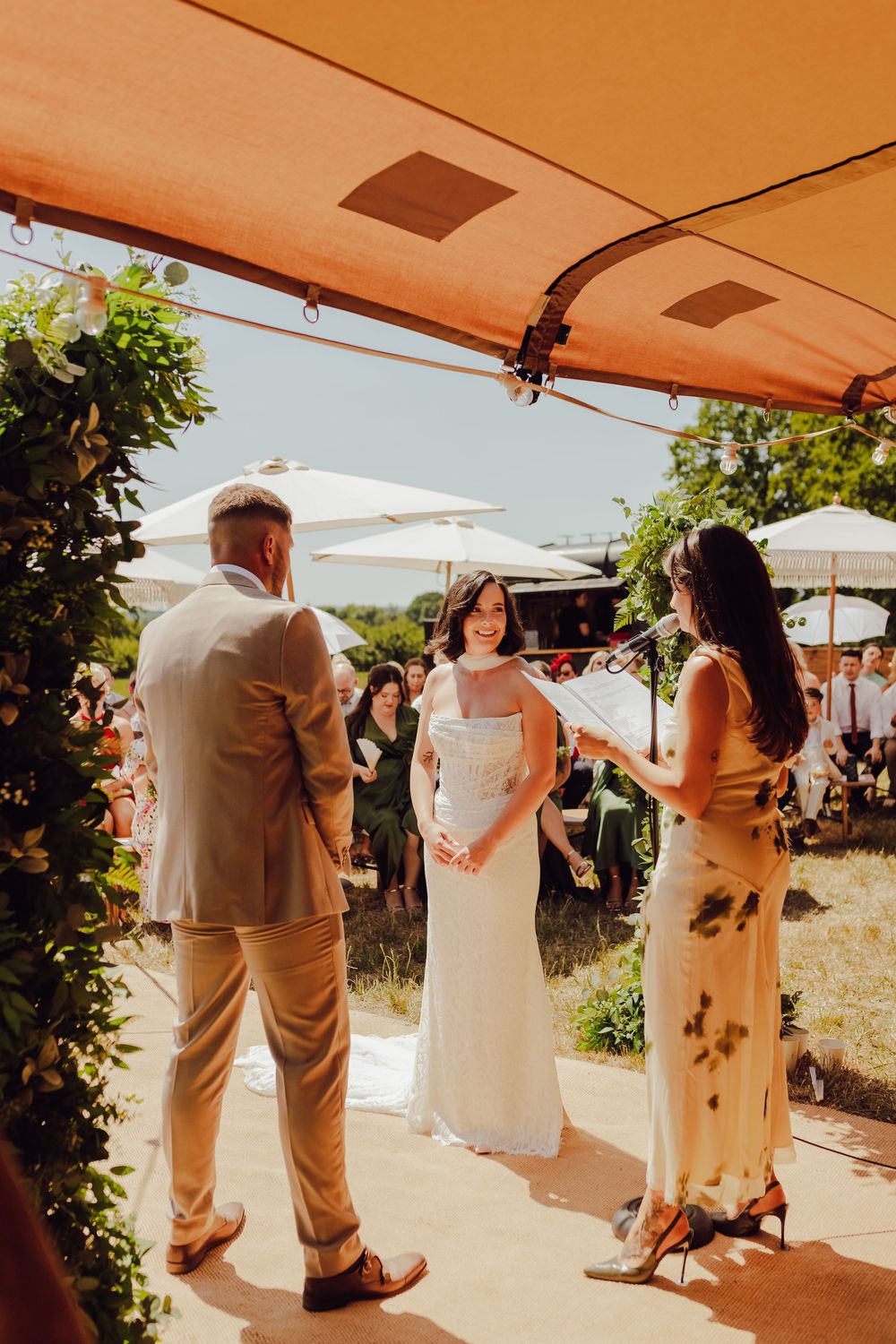 Amy and James standing together during their outdoor wedding ceremony in Romsey.