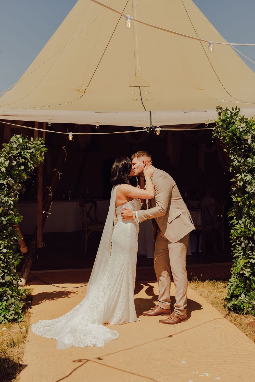 Bride and groom kissing for the first time after exchanging vows in Romsey.