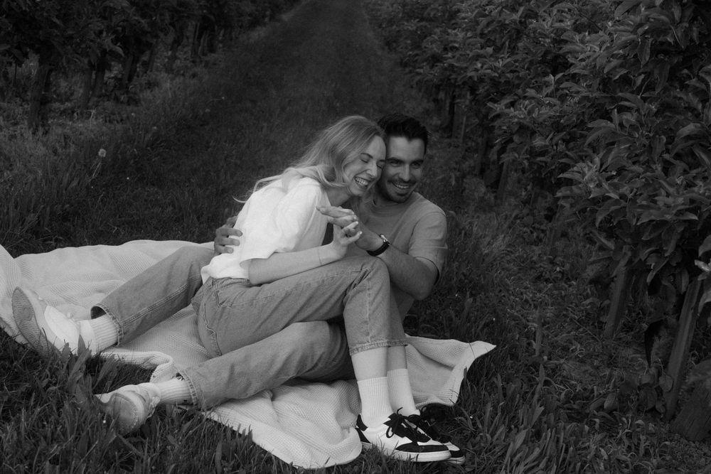 A photo sequence showing a pair lying in grass getting increasingly playful with each frame.