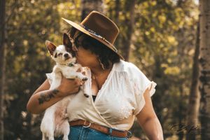 kissing her pup as a sign of affection and trust in the Yukon