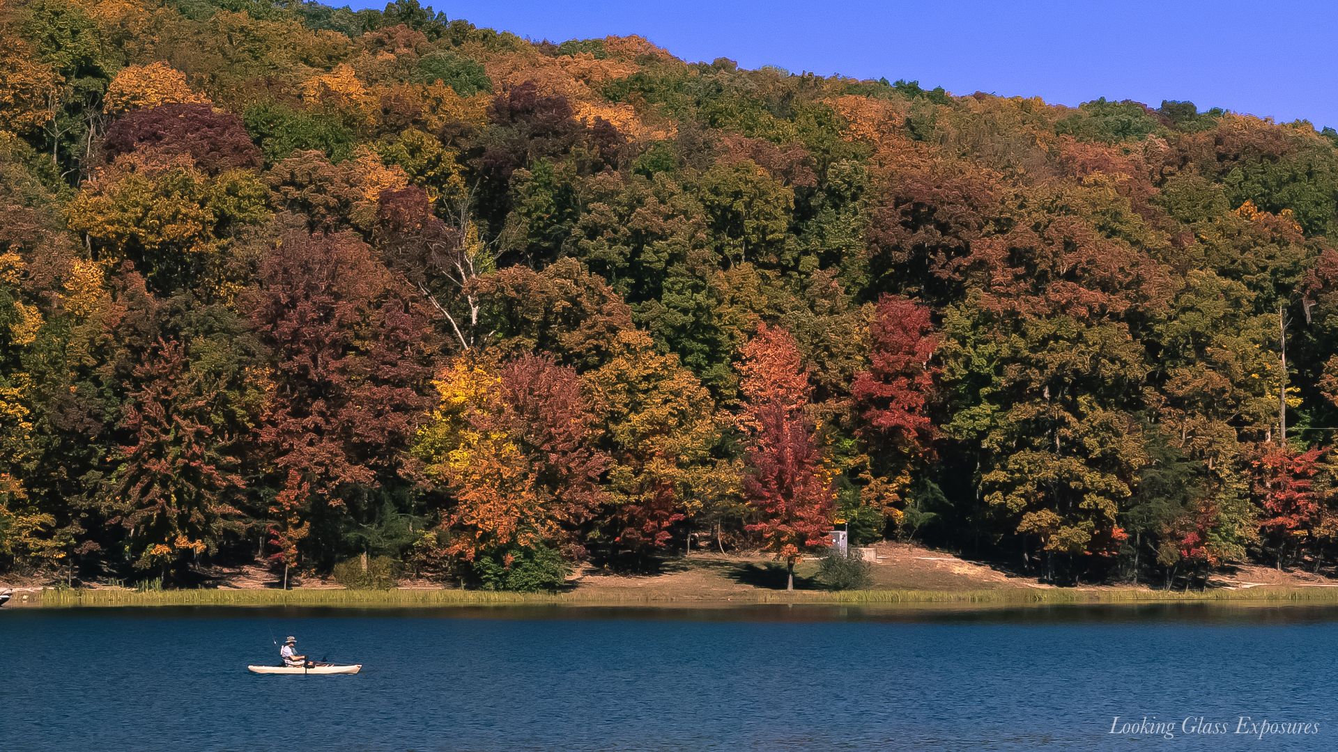 Bring A Paddle, is a telephoto shot of a lake, found after hiking down the mountain side. Many people were having picnics and enjoying life.