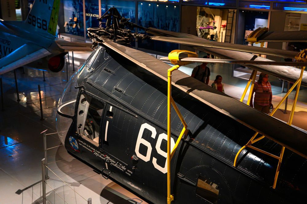 Vintage military aircraft with number 69 displayed in a museum setting.
