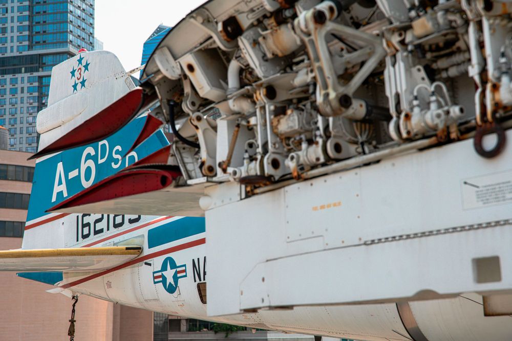 Close-up of an A-6 aircraft tail section showing military markings and mechanical details.