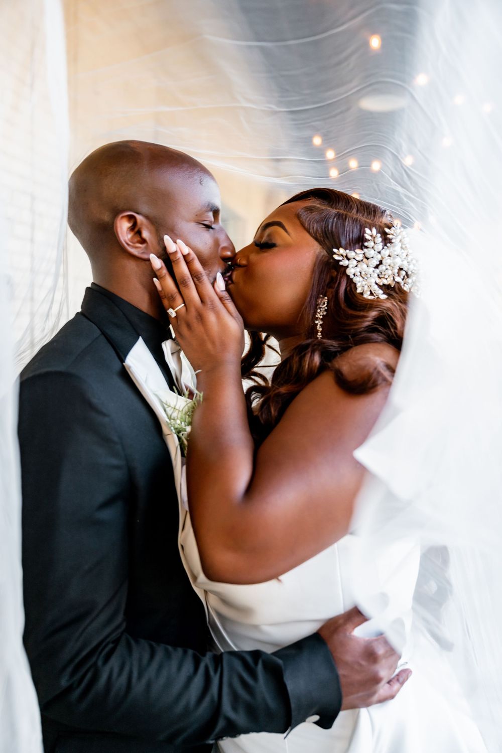 Romantic wedding couple sharing an intimate moment under flowing white fabric. wedding photography