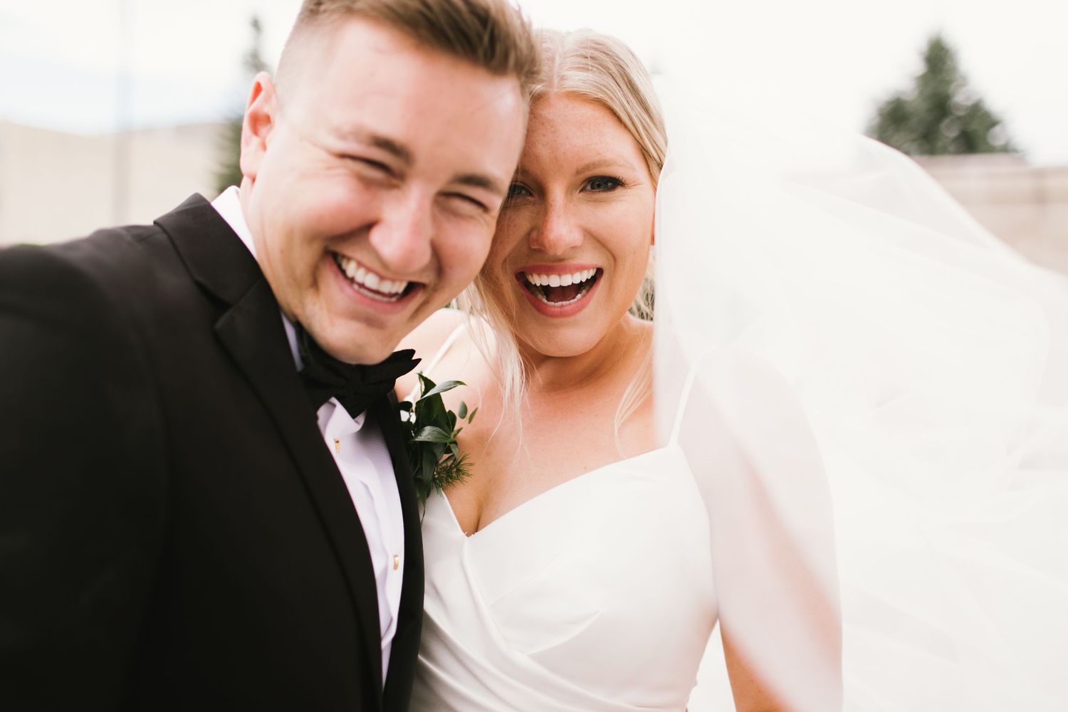 Close-up joyful moment captured during an outdoor wedding celebration.