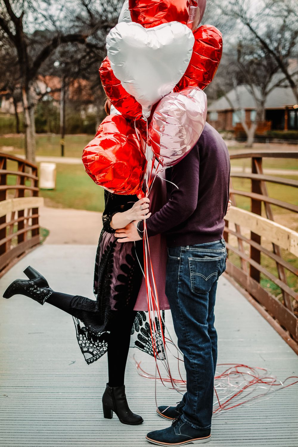 Valentines themed photoshoot in Fort Worth, Texas with heart balloons celebrating a couples first valentines day
