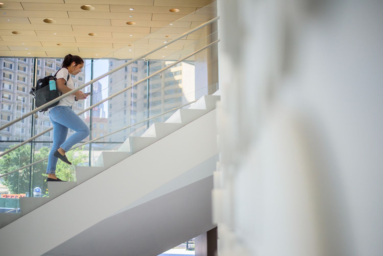 student walking up the stairs at Columbia business school HIGHER EDUCATION PHOTOGRAPHER, UNIVERSITY PHOTOGRAPHER