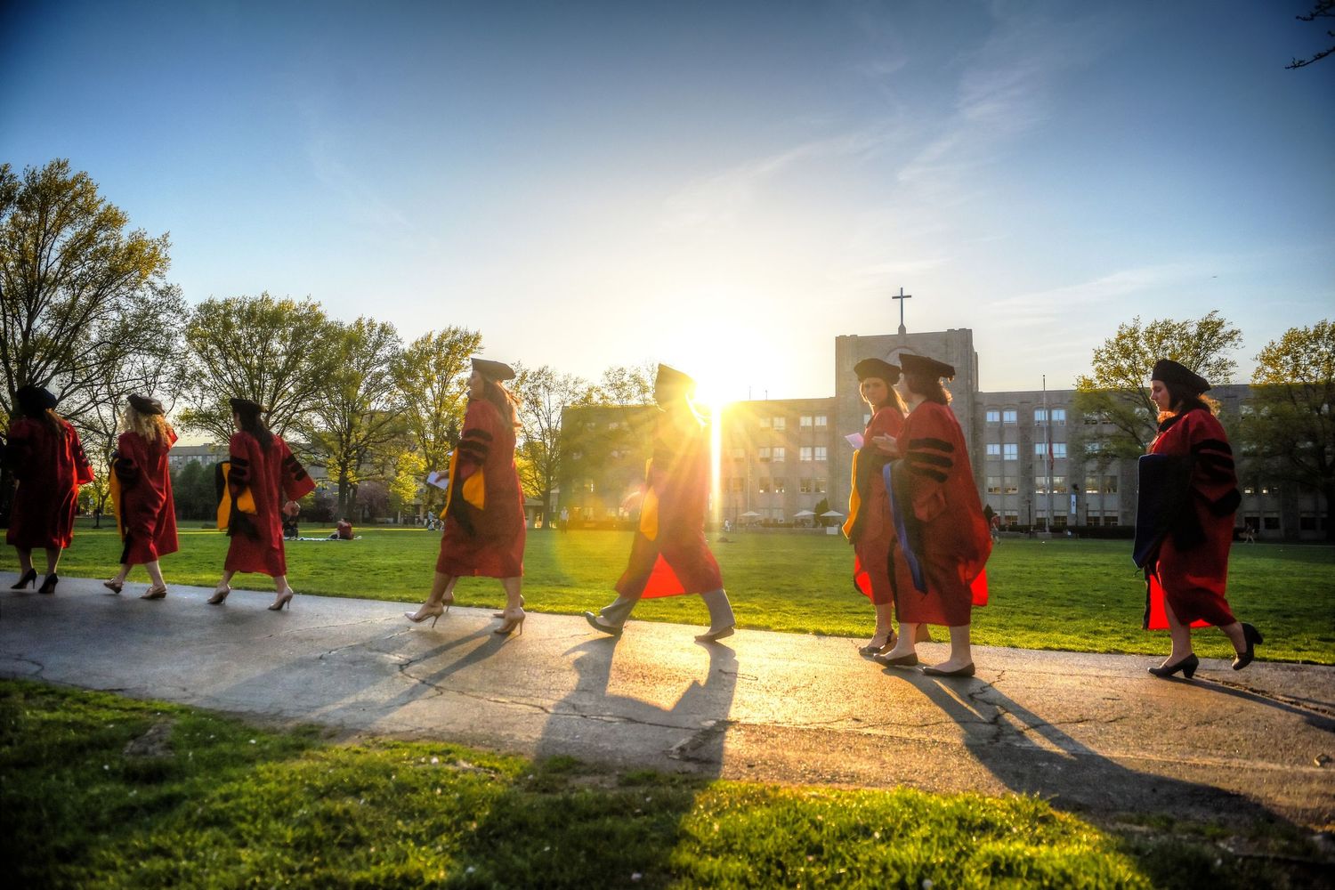 st. johns university graduates walking at sunset HIGHER EDUCATION PHOTOGRAPHER, UNIVERSITY PHOTOGRAPHER