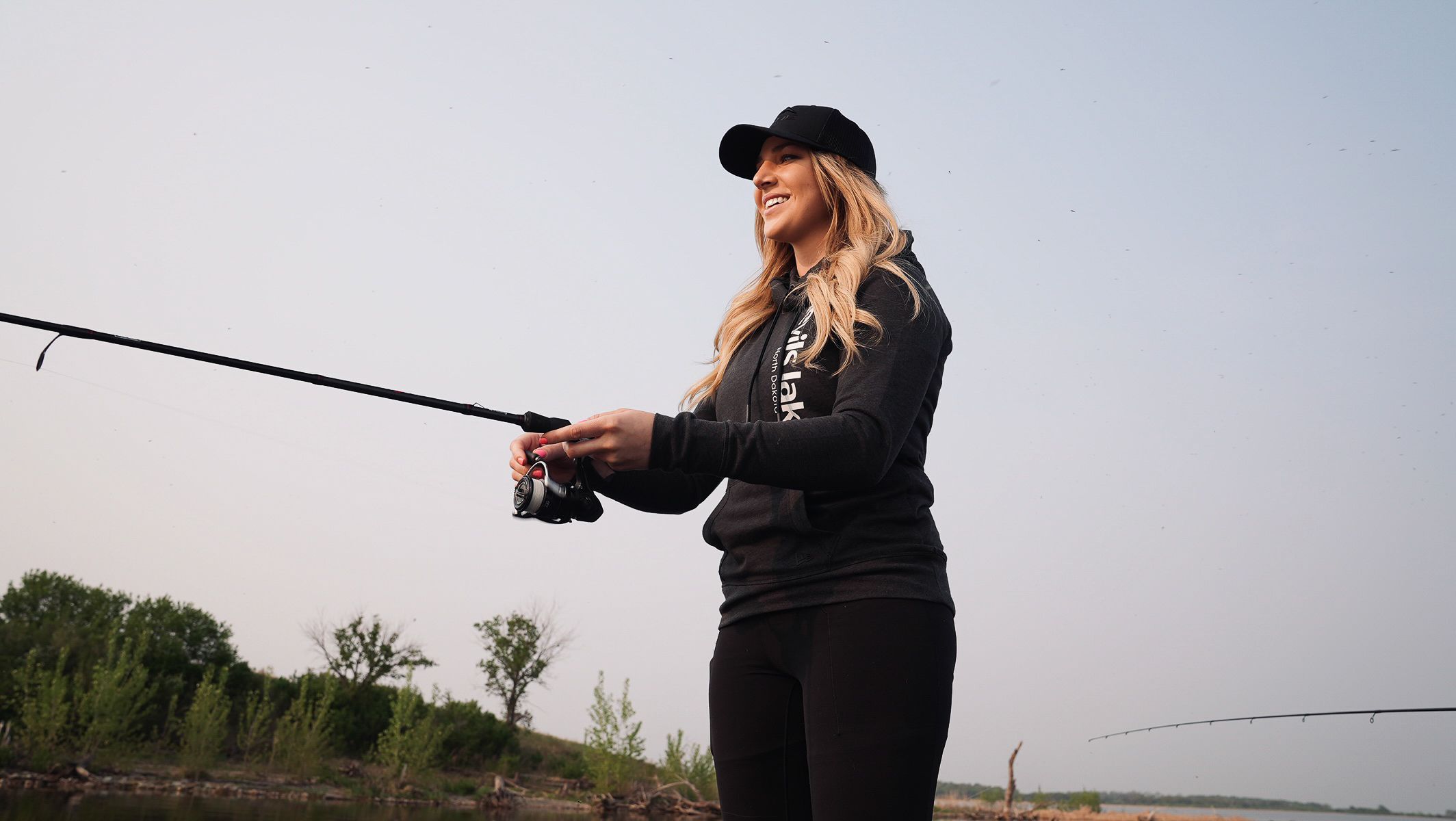 Fishing rods extended over water during a fishing expedition.
