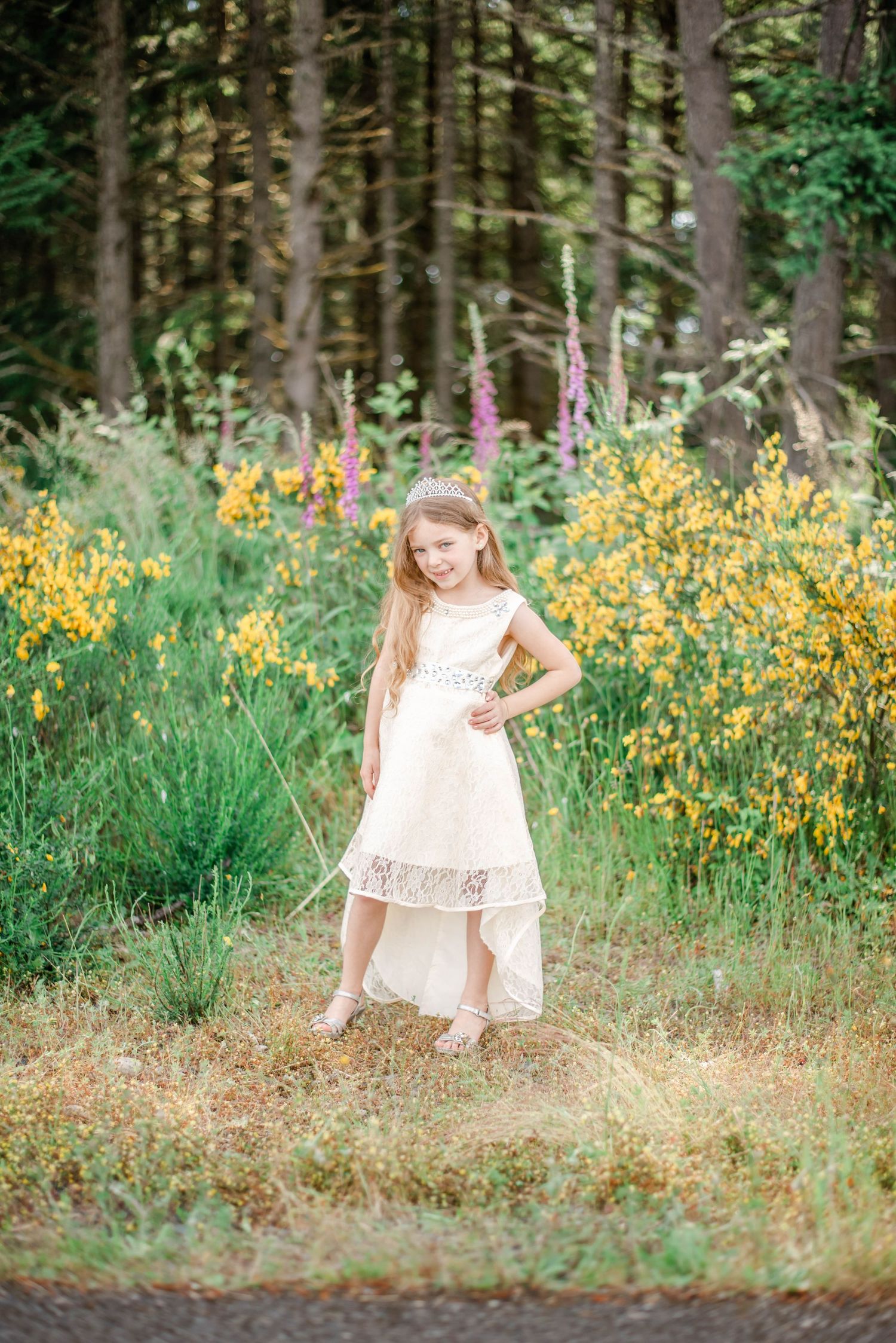 A whimsical scene of someone in a cream dress dancing among yellow wildflowers and forest trees.
