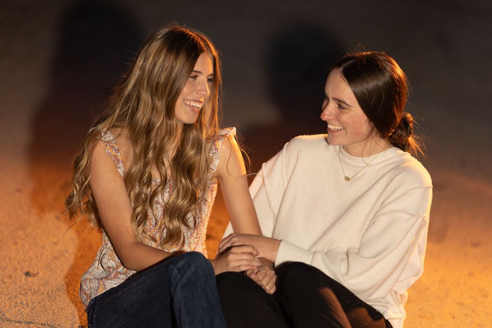 Best friends laughing at the end of a long senior portrait session outside of Neoga, Illinois.