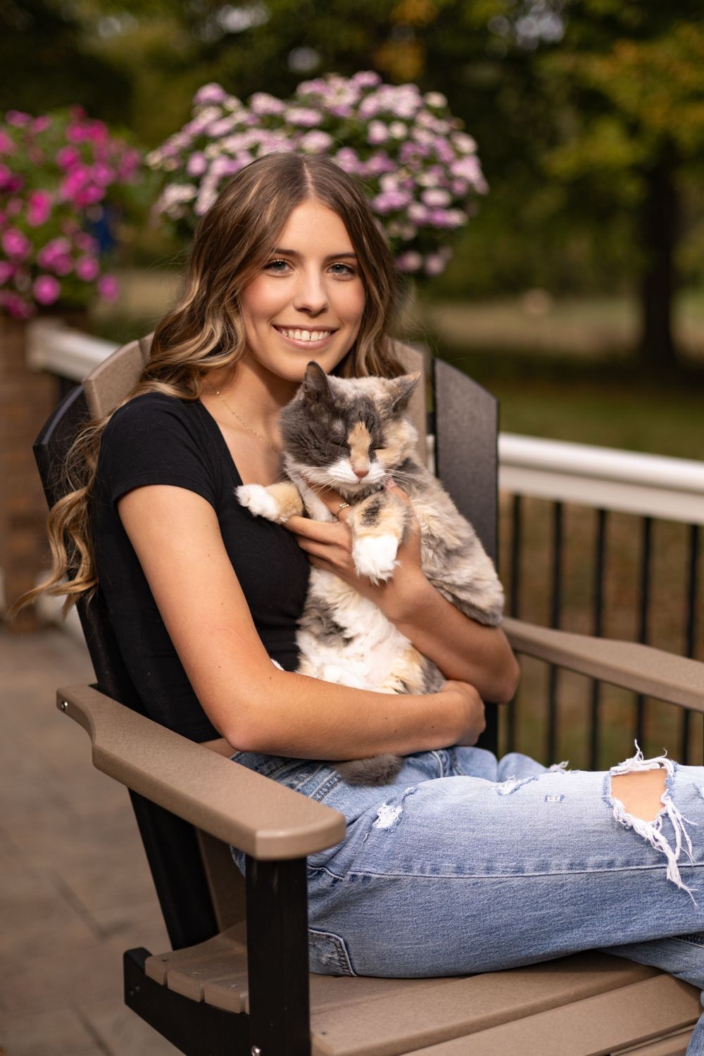 Animals bring emotion to senior portraits. This young lady posed with her cat.