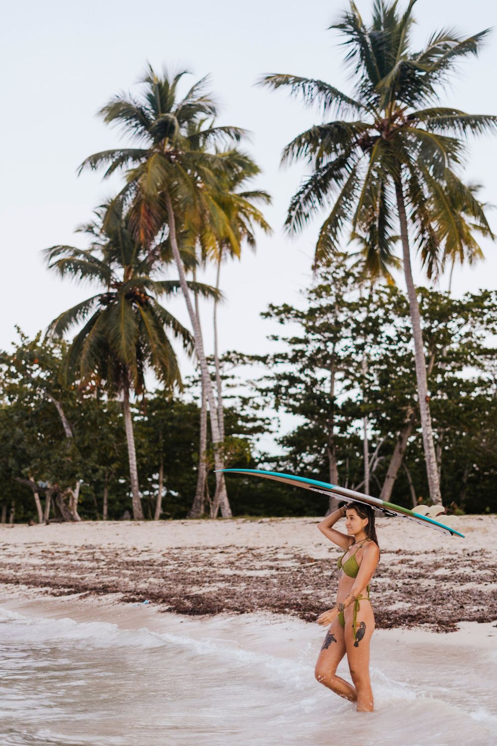 A series of beach photos showing palm trees and a person in a bikini enjoying the tropical shoreline at sunset.