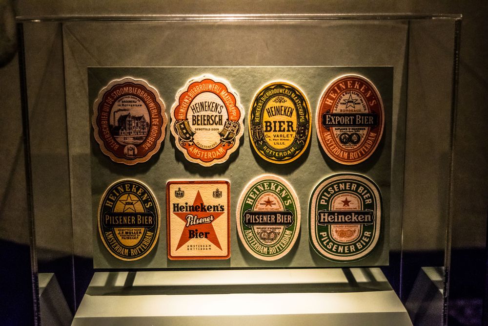 Display case showing vintage beer labels and brewery logos in traditional designs.