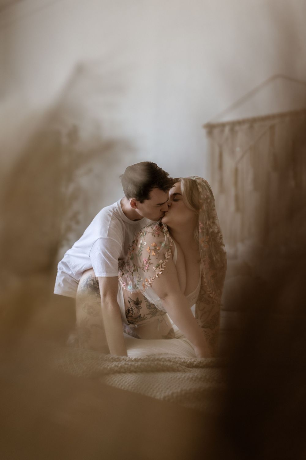 Romantic sepia-toned photograph of couple sharing tender moment.
