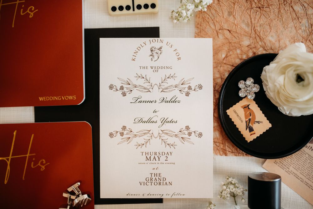Elegant wedding invitation featuring floral designs and calligraphy on white paper.