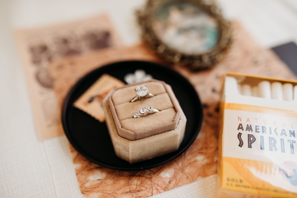 Wedding ring in velvet box with vintage styling and decorative elements.