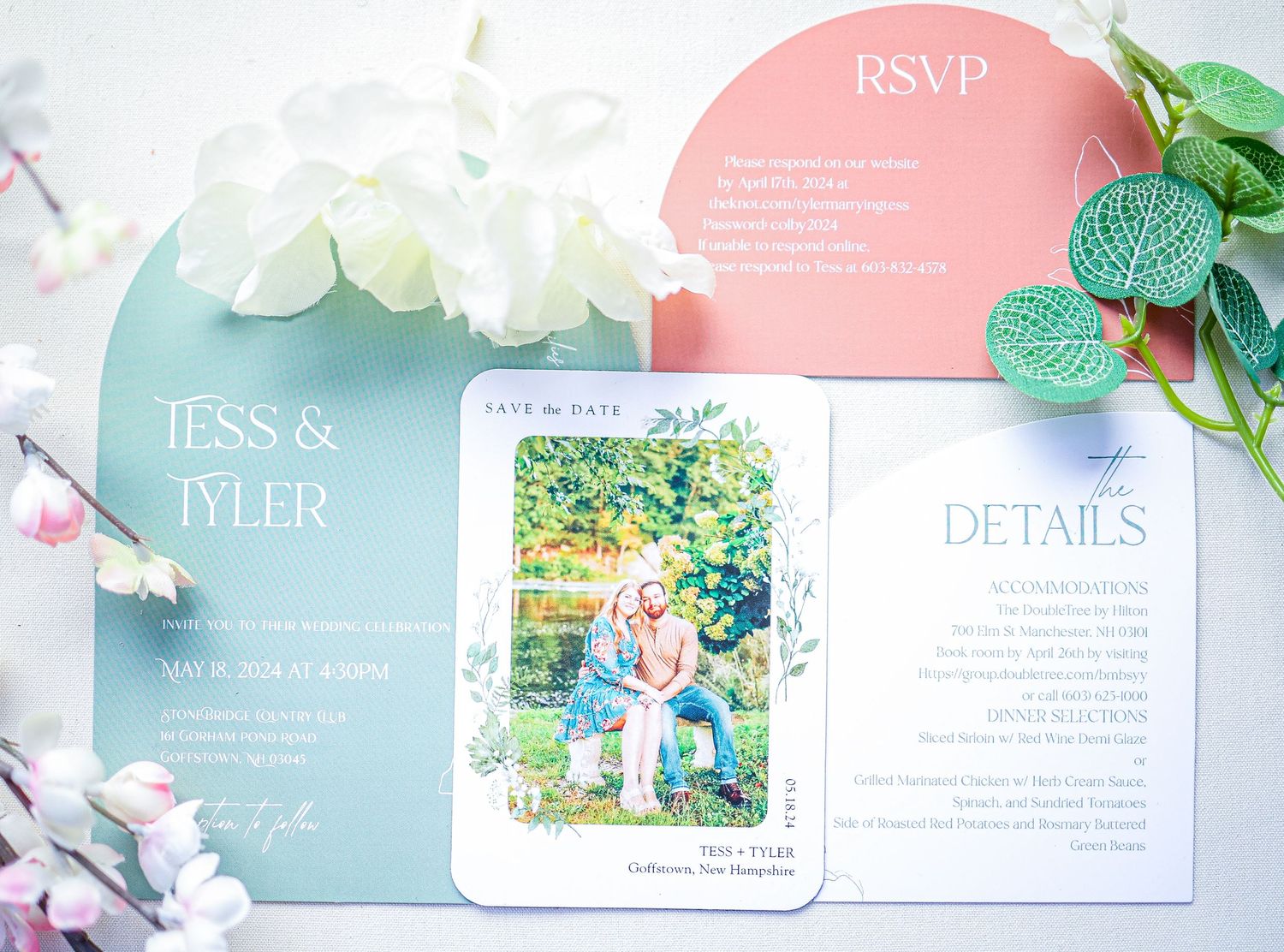 Wedding invitation suite featuring mint green and coral cards with white flowers and eucalyptus accents.