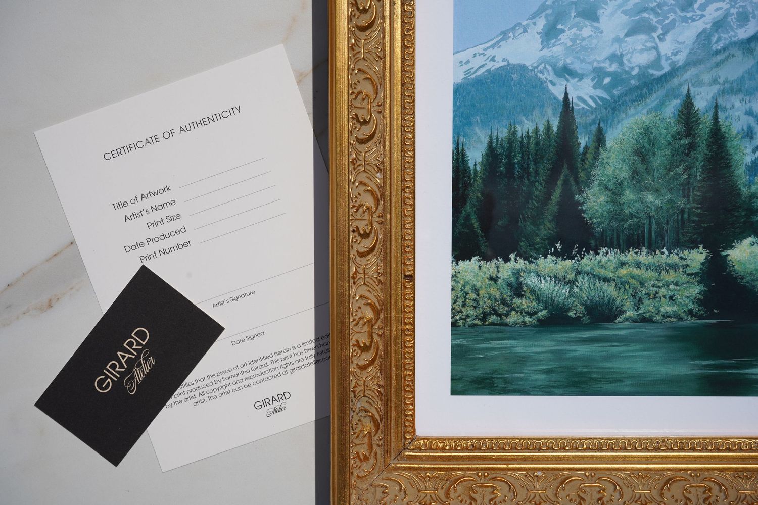 Details of a framed print with business card beside it