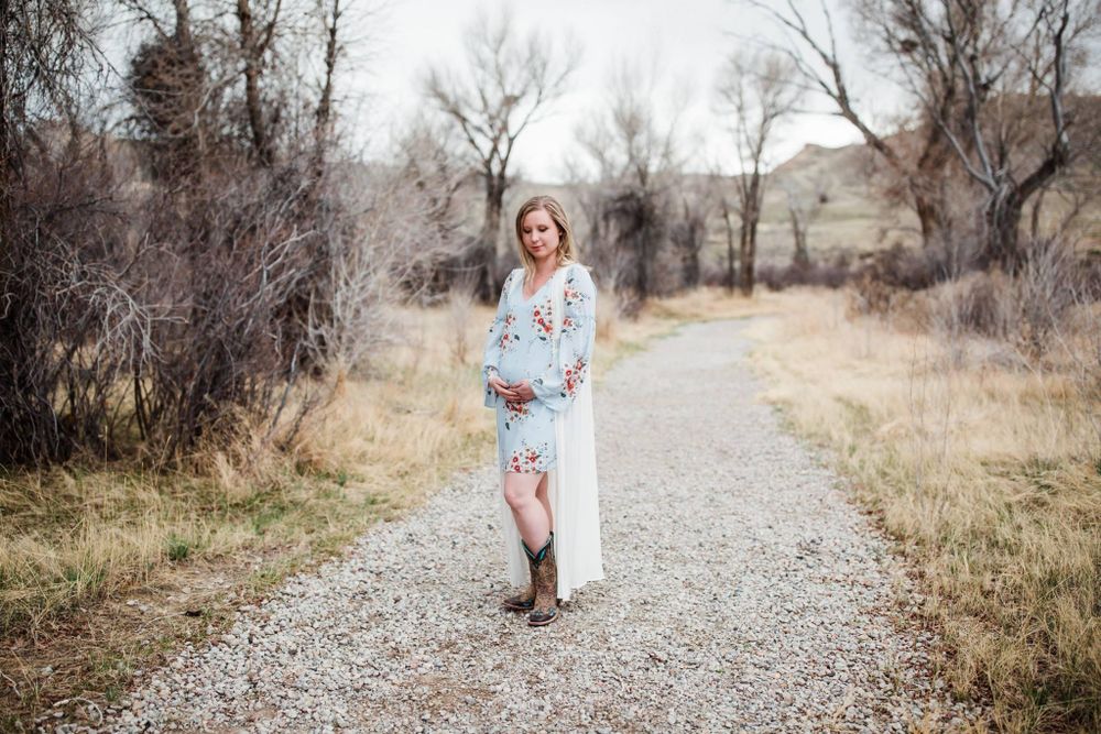 Pregnant woman posing on road