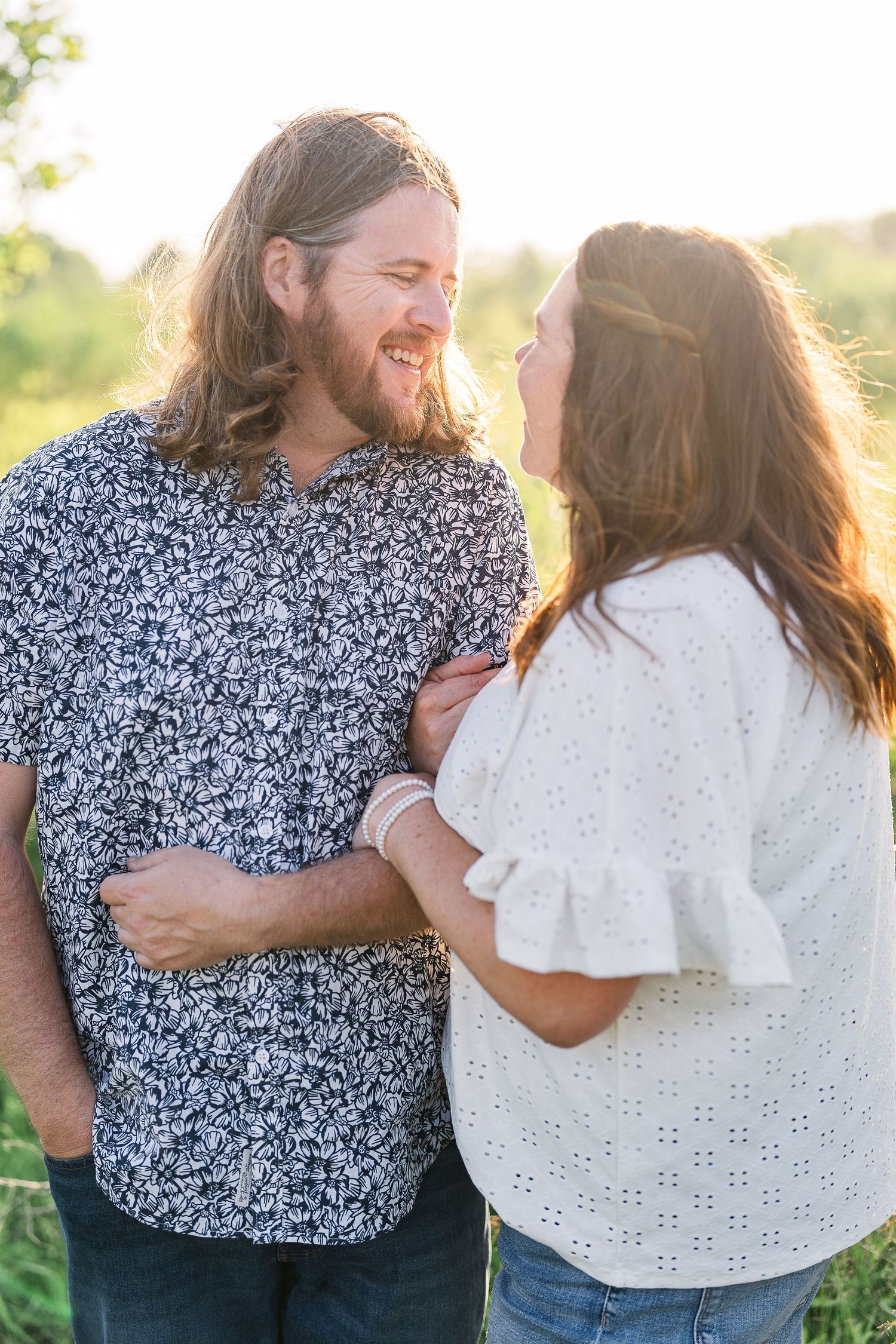 Engaged couple laughing and playfully interacting during their Kenosha engagement session.