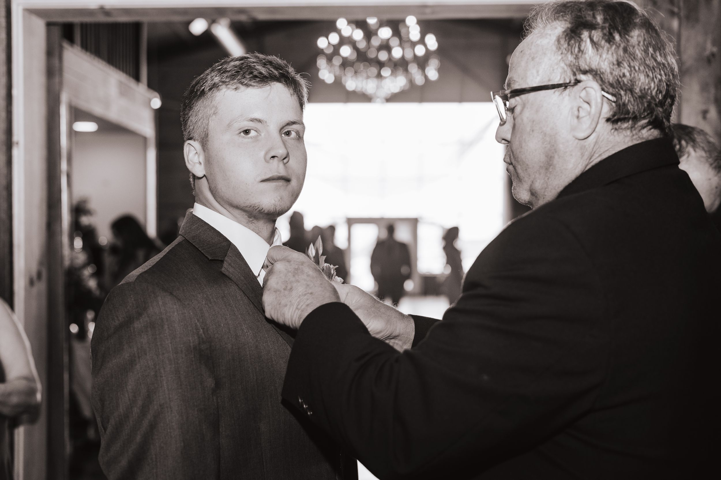 Wedding guests mingle and socialize during an elegant indoor reception celebration.
