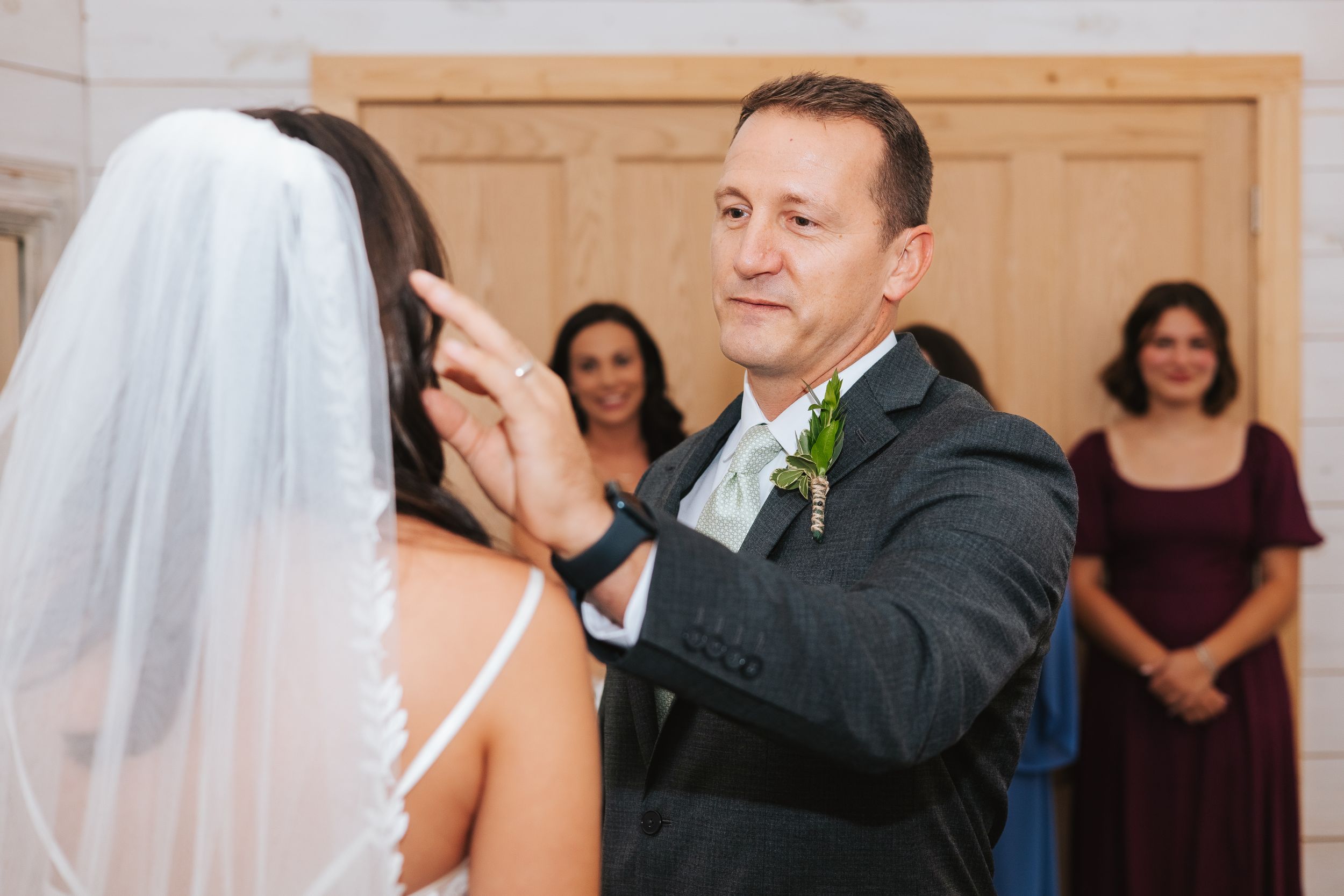 Guests dance together during an elegant indoor wedding reception.