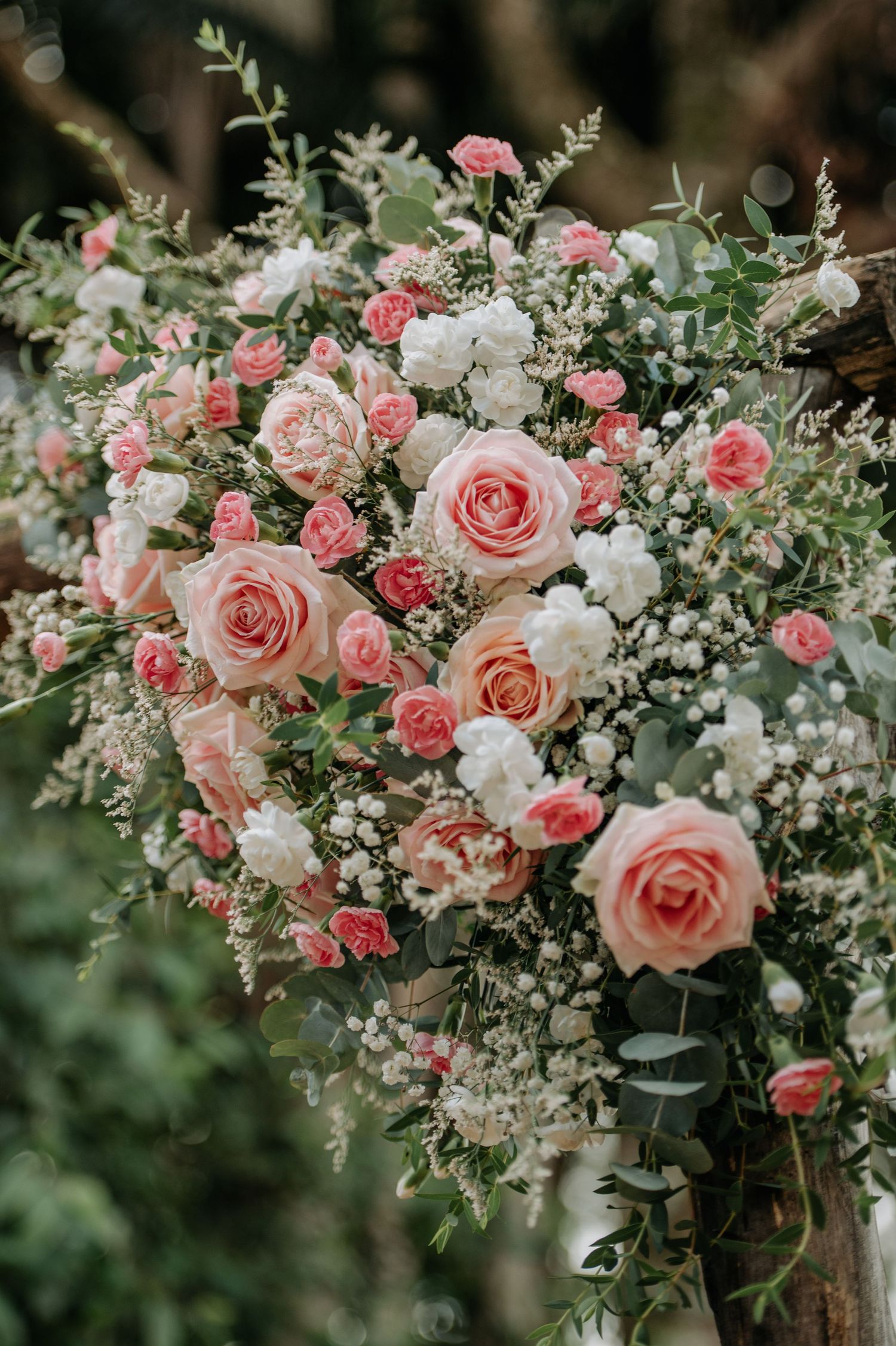 Stunning floral arrangement featuring pink and white roses with delicate greenery.