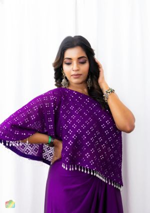 Elegant purple sequined ethnic wear with silver fringe detail against white background.