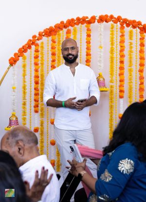 Event setup with orange and yellow marigold flower decorations against white backdrop.