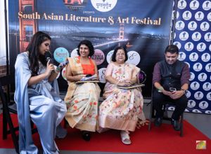 Panel discussion at South Asian Literature & Art Festival with speakers seated on stage.