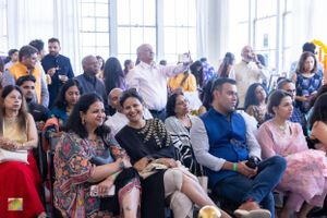 Diverse audience members enjoying presentations at cultural festival event.