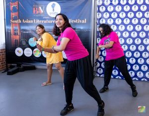 Group performs energetic dance moves at South Asian Literature Festival.