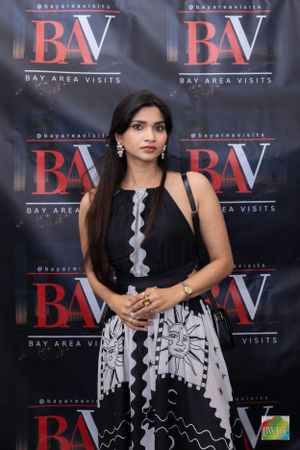 A formal event with a black and red BAV (Bay Area Visits) step-and-repeat banner backdrop.